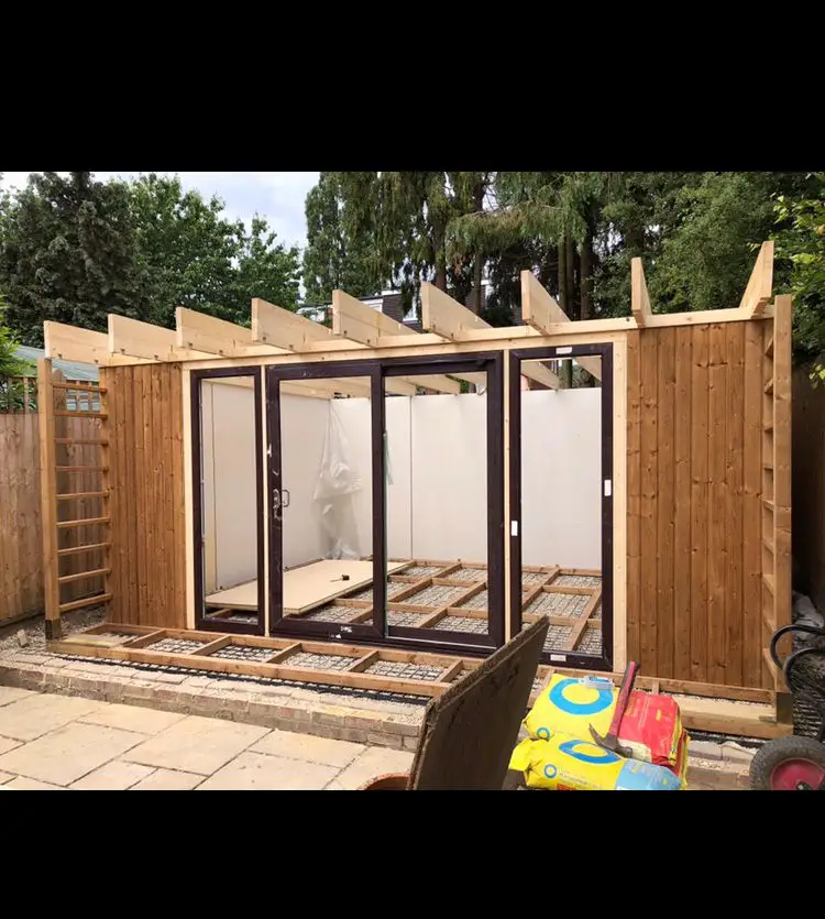 Garden room and pergola structure under construction with cladded walls in Kent