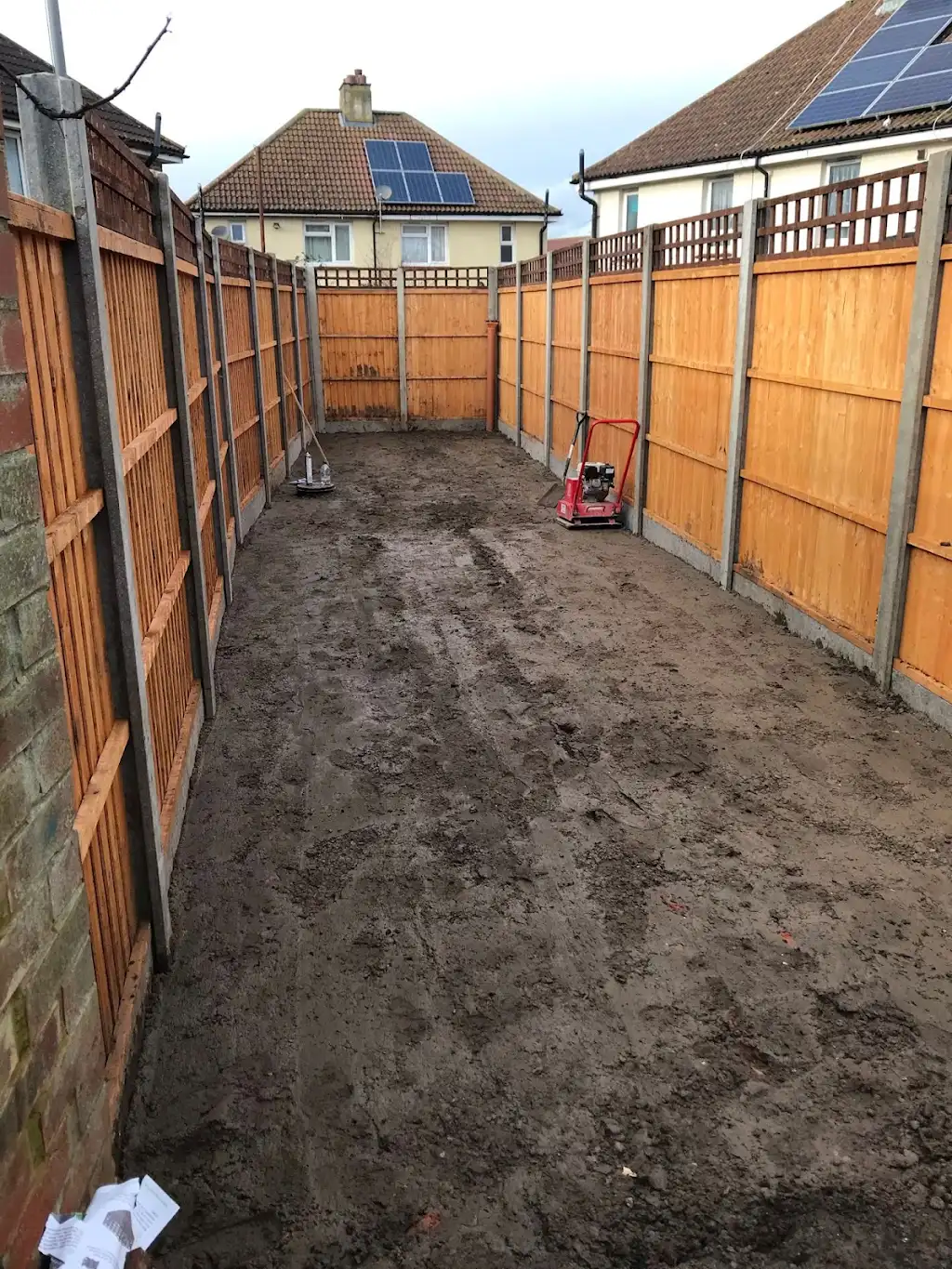 Full-length garden with brand new fencing on both sides, prepared for landscaping in Kent